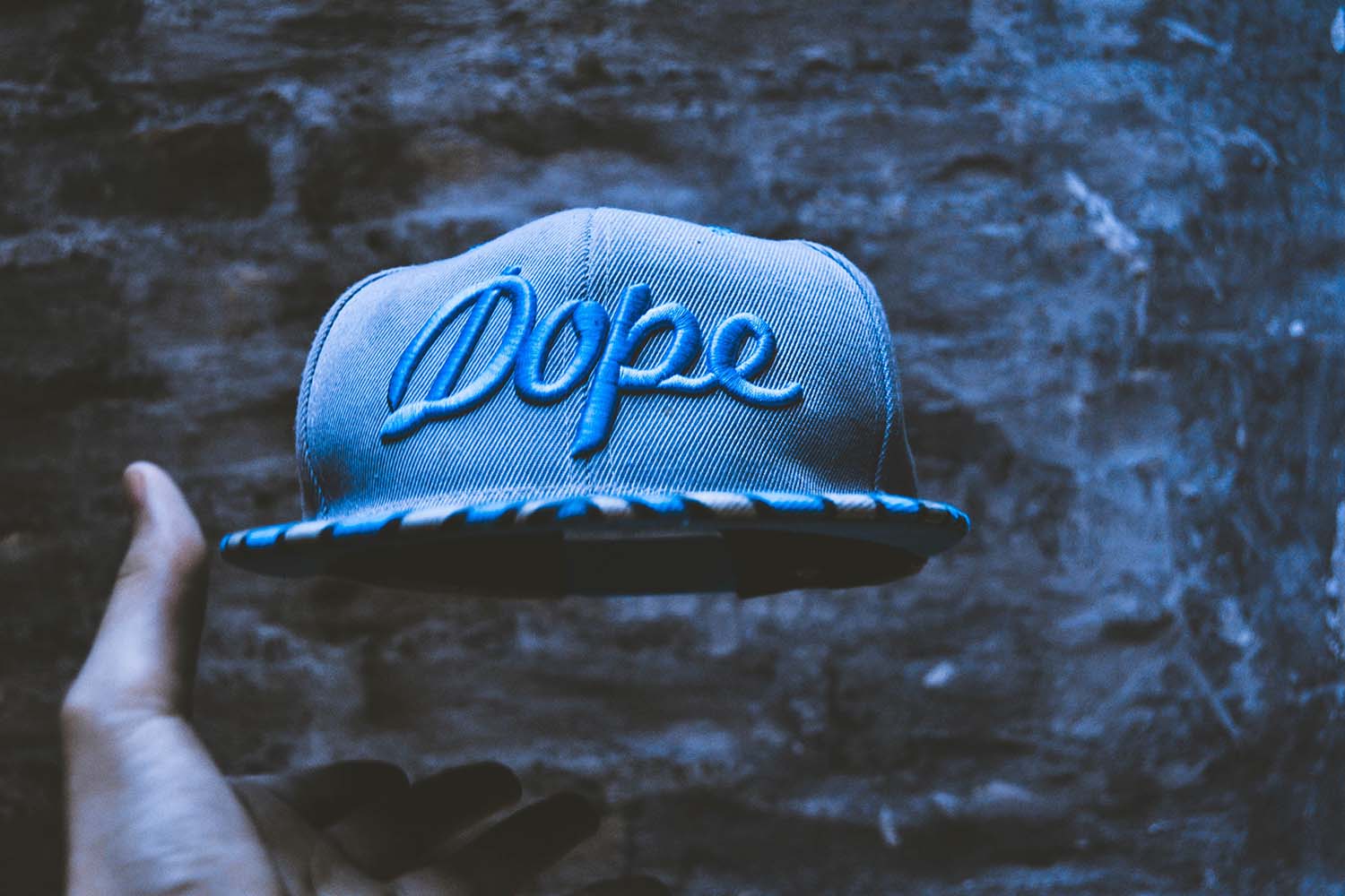 3d puff embroidered cap in blue against chaotic background